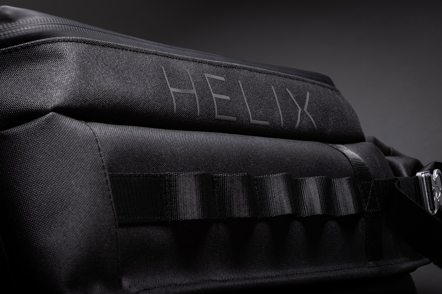 Close-up view of the side attachment loops of the Helix Stadium Backpack
