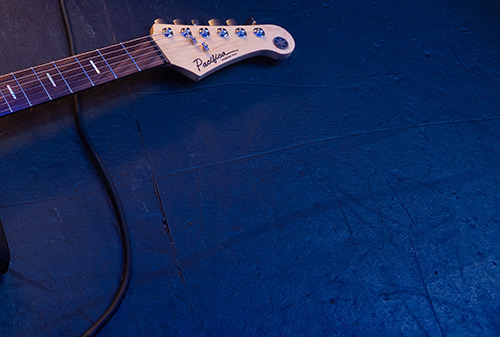 cut up image with guitar neck and headstock