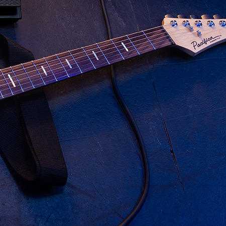 cut up image with guitar neck and headstock