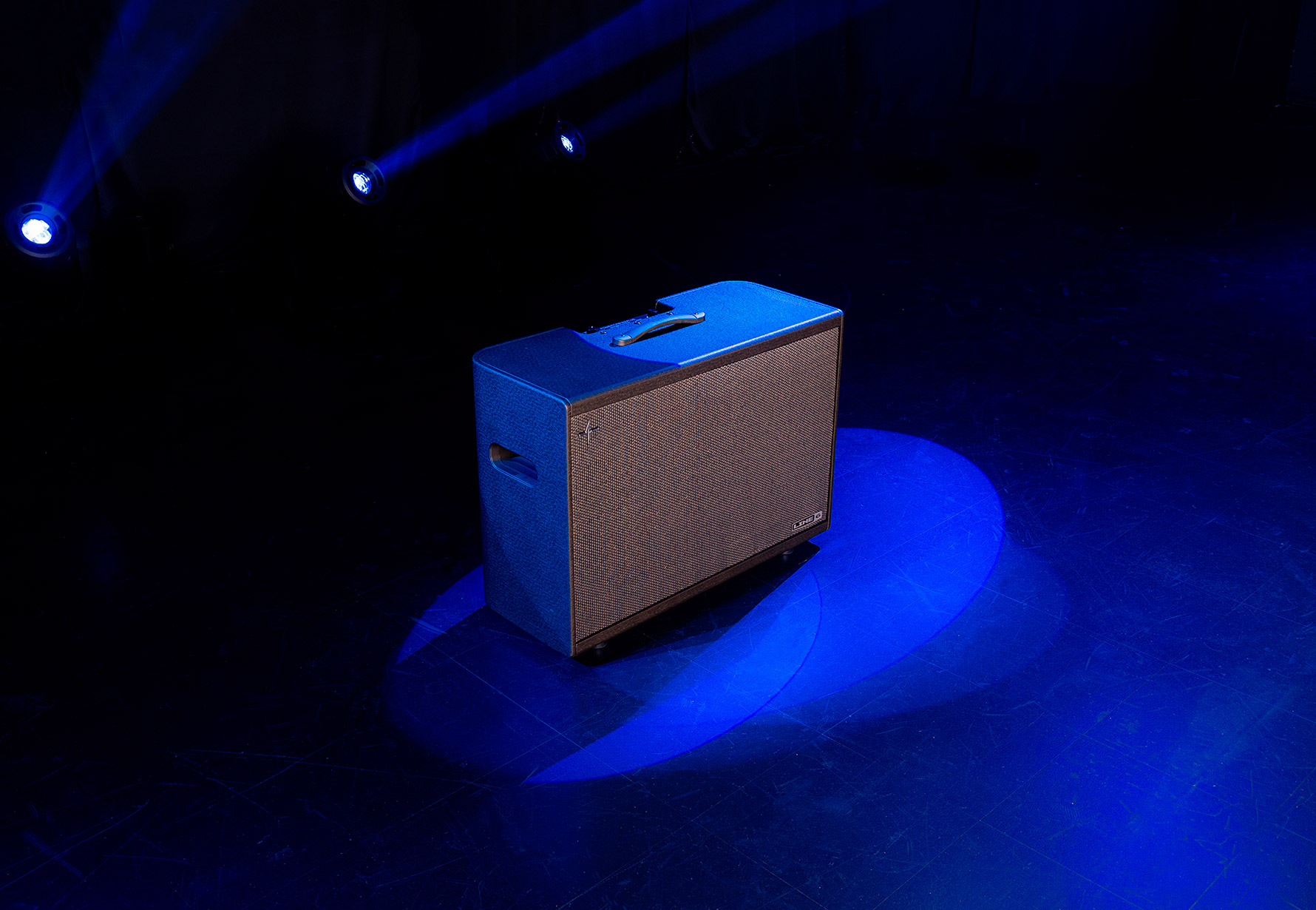 Powercab 212 Plus on stage with blue spotlight